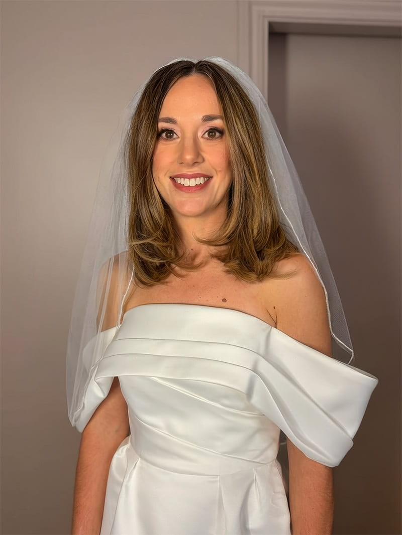 Smiling bride with natural glowing makeup and veil in Hampshire