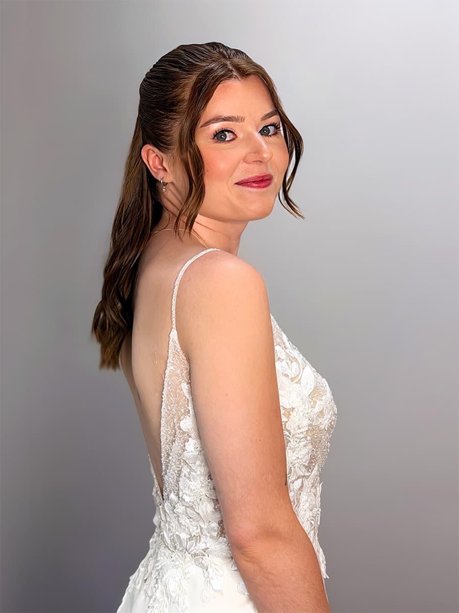 Bridal makeup with berry lip and half-up waves in lace wedding dress