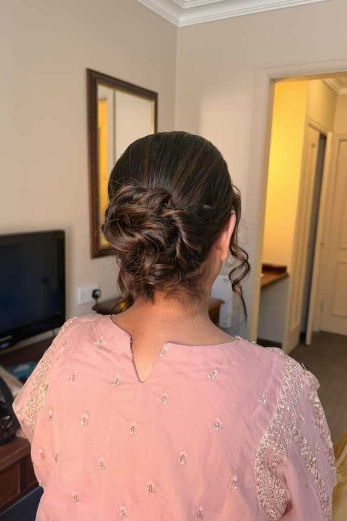 Low textured bridal bun with loose tendrils, Winchester Hampshire